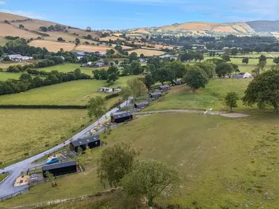 an aerial view of a farm with cars on a road at The Fox Den in Rhayader