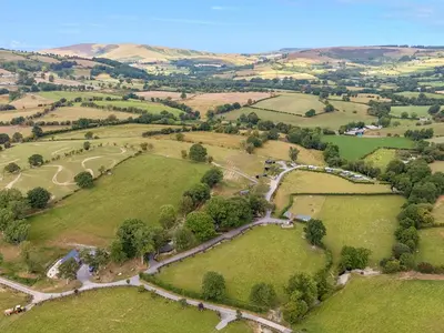 an aerial view of a farm in the hills at Hillside Lodge in Rhayader