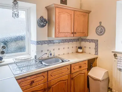 a kitchen with a sink and a window at New Cottage in Penmaenpool