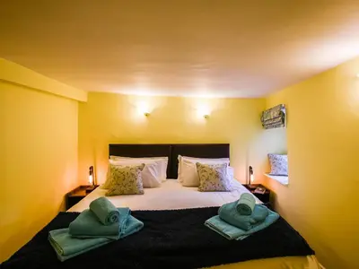 a bedroom with a bed with two towels on it at Glasfor in Llwyngwril