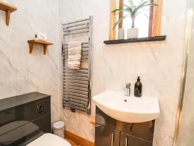 a bathroom with a sink and a toilet at Highland View in Rhayader