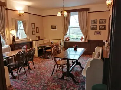 a dining room with a table and chairs at Lion Hotel in Llanbister