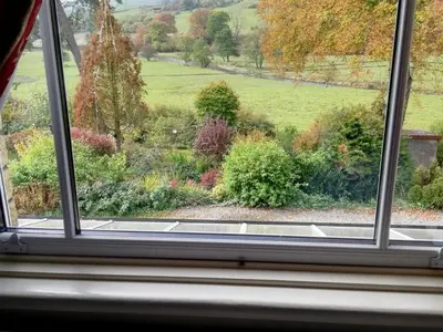 a view of a garden from a window at Lion Hotel in Llanbister