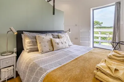a bedroom with a bed with a large window at 1 Bed in Aberaeron oc-bow300 in Henfynyw Upper