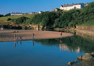 a group of people standing on a small island in the water at 1 Bed in Aberaeron oc-bow300 in Henfynyw Upper