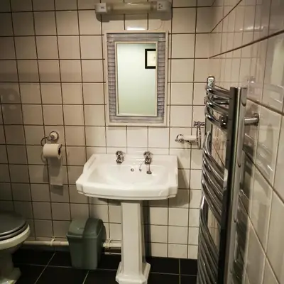a bathroom with a sink and a mirror at Rooms by the River at Glan Aber in Cynwyd