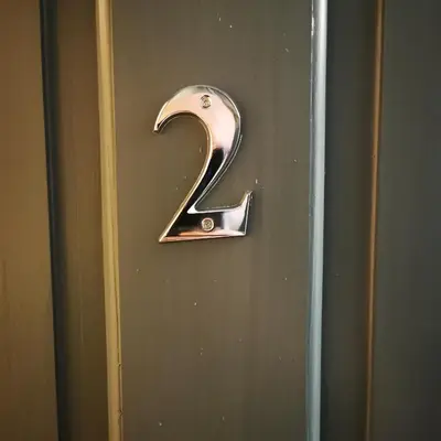 a door number with the number two on the door at Rooms by the River at Glan Aber in Cynwyd