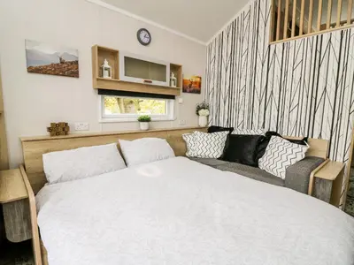 a bedroom with a bed and a couch at Oak Tree View in Rhayader
