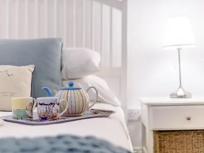 a tray with cups and tea pots on a bed at Apartment 1 - Uk32244 in Aberdyfi
