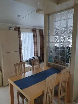 a dining room with a table and chairs at Barmouth Lyons Sunnysands 346 in Talybont