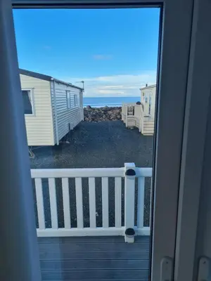 a view of the ocean from a house balcony at Barmouth Lyons Sunnysands 346 in Talybont