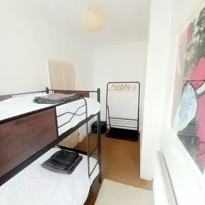 a room with two bunk beds and a mirror at Chapel Cottage in Machynlleth