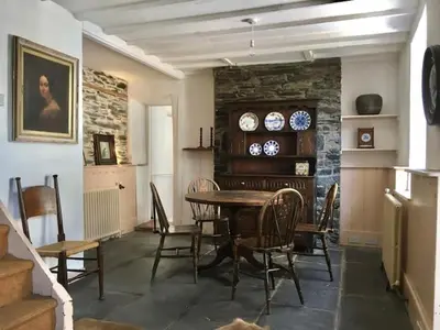 a dining room with a table and chairs at Chapel Cottage in Machynlleth