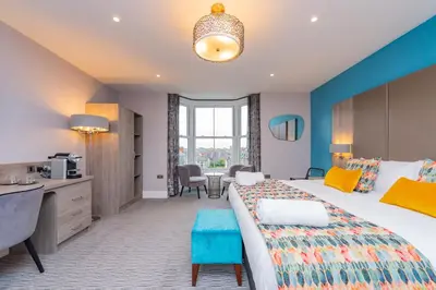 a hotel room with a bed and a desk at Townhouse No.1 in Aberystwyth