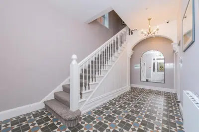 a staircase in a home with a hallway with a stair treadeway at Townhouse No.1 in Aberystwyth