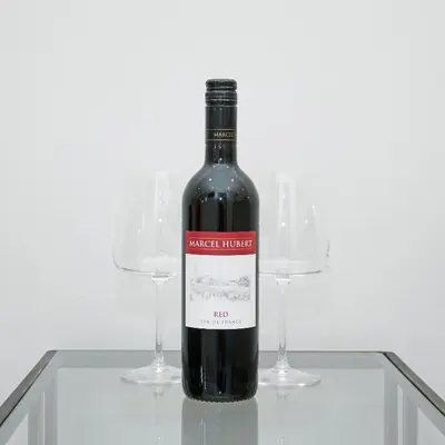 a bottle of wine sitting on a table with two wine glasses at Townhouse No.1 in Aberystwyth