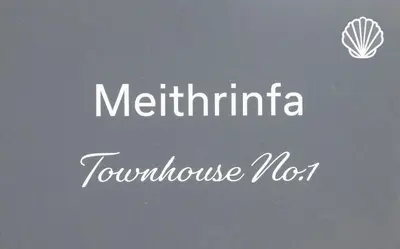 a sign with the wordsmetlinatio tovolumesmitemitemitemite at Townhouse No.1 in Aberystwyth
