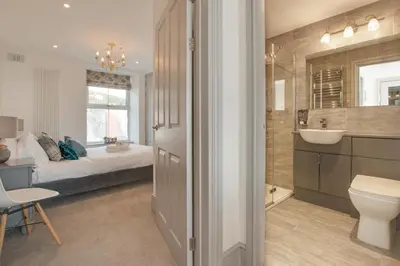 a bathroom with a bed and a sink and a toilet at 1 Bed in Aberystwyth oc-bow286 in Aberystwyth