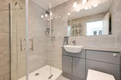 a bathroom with a glass shower and a sink at 1 Bed in Aberystwyth oc-bow286 in Aberystwyth