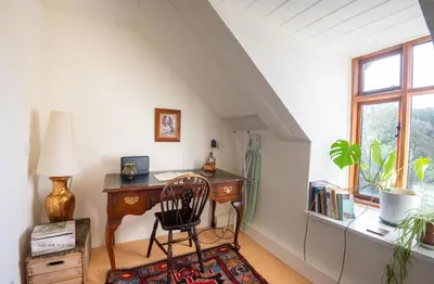 an attic room with a desk and a chair at Panoramic Mountain Retreat - Waen Fechan - 4x4 access only in Dolgellau