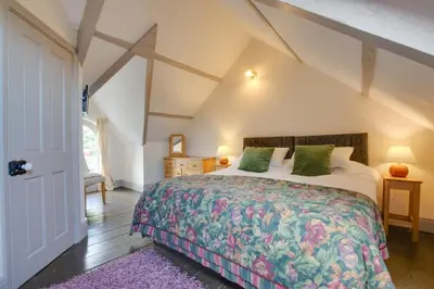 a bedroom with a large bed in a attic at 4 Bed in New Quay oc-bow272 in New Quay