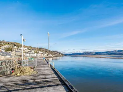 a dock with a view of a body of water at Pebble Cottage in Aberdyfi