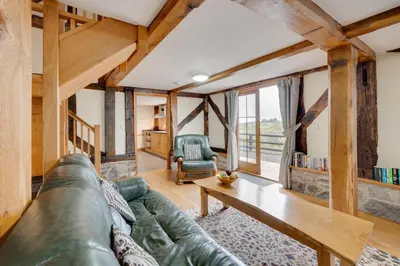 a living room with a green couch and a table at 2 Bed in Y Drenewydd oc-waa401 in Llanllugan