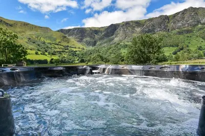 a dam on a river with mountains in the background at 4 Bed in Dinas Mawddwy oc-bow305 in Aber Cowarch