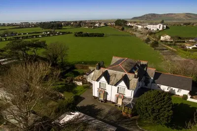 an aerial view of a large house in a field at Leahurst Bed and Breakfast in Tywyn