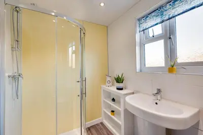 a bathroom with a sink and a glass shower at 2 Bed in Tregaron oc-bow298 in Tregaron