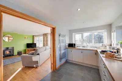 a kitchen and living room with a couch and a table at 2 Bed in Tregaron oc-bow298 in Tregaron