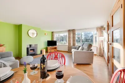 a living room with green walls and a table and chairs at 2 Bed in Tregaron oc-bow298 in Tregaron