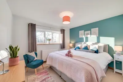 a bedroom with a large bed and a blue wall at 2 Bed in Tregaron oc-bow298 in Tregaron