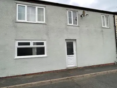 a gray building with white windows and a door at Westend Holiday Let 3 Brecon in Brecon