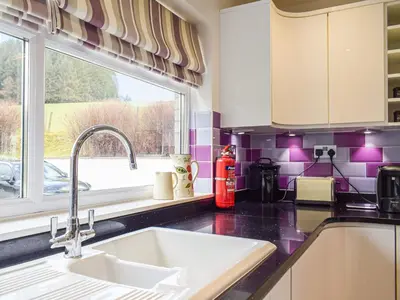 a kitchen with a sink and a window at Rhiw Gam in Abbey-Cwmhir
