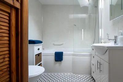 a bathroom with a tub and a toilet and a sink at Homely cottage with garden and mountain-view in Blaenau-Ffestiniog
