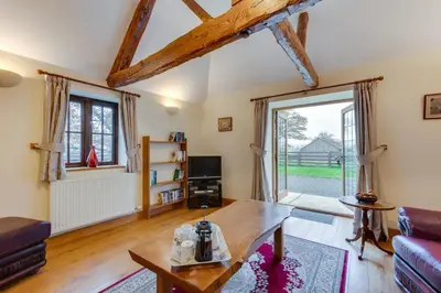 a living room with a couch and a table at 2 Bed in Y Drenewydd oc-waa402 in Llanllugan