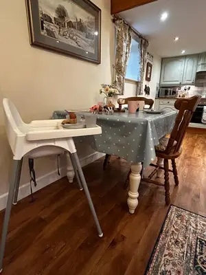 a table in a kitchen with a table and chairs at The Old Milking Parlour Flyingpiglets in Llandovery