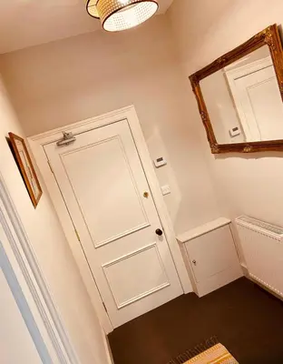 a bathroom with a white door and a mirror at NiCheGetaway in Shrewsbury