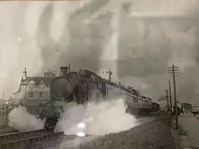 an old photo of a steam train on the tracks at The Queens Hotel Harlech in Harlech