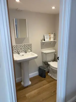 a bathroom with a sink and a toilet at The Stables at Pentregaer Ucha, tennis court & lake in Oswestry