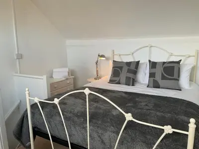 a bedroom with a large bed with pillows at Pass the Keys 3 bedroom home within walking distance of town in Shrewsbury