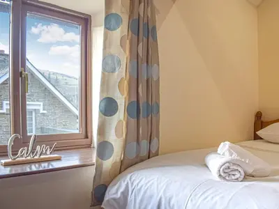 a bedroom with a bed and a window at Border View in Kington