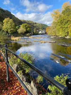 a view of a river from a bridge at Abbey Cottage in Llangollen
