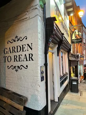 a sign for a garden to hear on the side of a building at Cartref - Fully equipped and stunning town flat in Shrewsbury