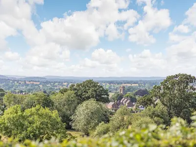 a view of a city from a hill with trees at Elsie's Cottage in Pontesbury