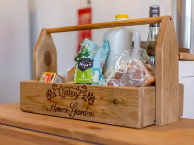 a wooden box with food on a table at Elsie's Cottage in Pontesbury