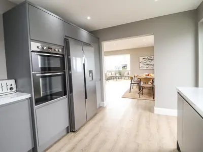 a kitchen with stainless steel appliances and a dining room at Bryn Hafod in Dyffryn