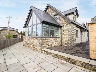 an image of a stone house with a patio at Bryn Hafod in Dyffryn