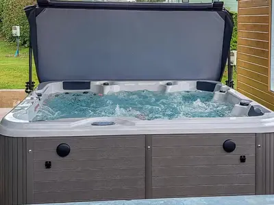 a hot tub with water inside of it at Lake Vyrnwy Luxury Glamping Pod 2 in Llanwddyn